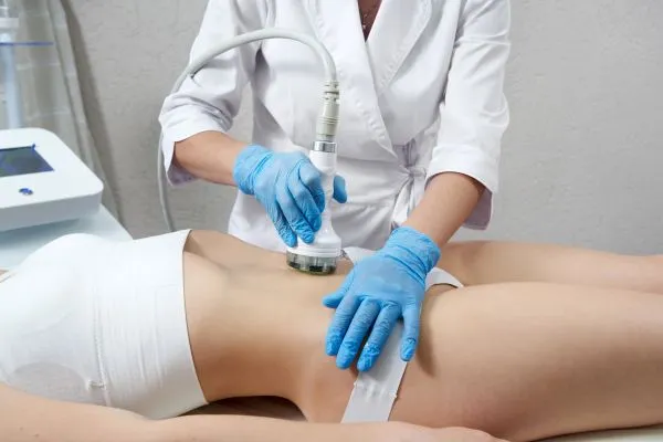 Lost the Weight but Not the Loose Skin? 2 woman having HIFU treatment on her stomach to combat loose skin Llanelli following weight loss